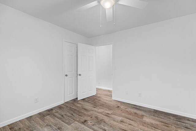 empty room featuring ceiling fan and light wood-type flooring