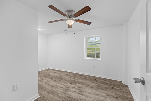 empty room featuring ceiling fan and hardwood / wood-style floors