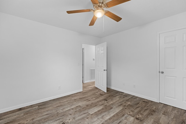 unfurnished room with hardwood / wood-style floors and ceiling fan