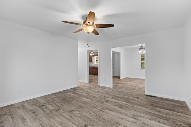 unfurnished living room with plenty of natural light, ceiling fan, and light hardwood / wood-style flooring