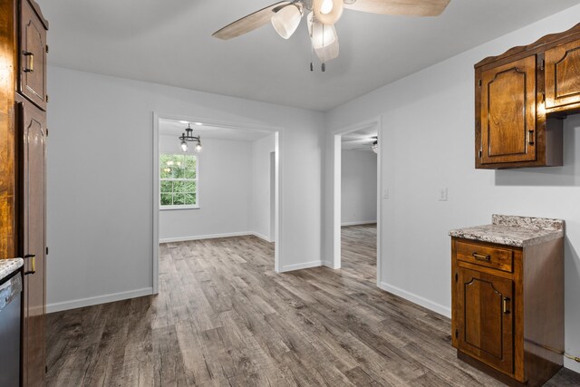 kitchen featuring ceiling fan, dishwashing machine, and hardwood / wood-style flooring