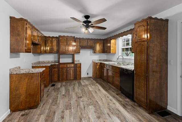 kitchen featuring dishwasher, sink, ceiling fan, light wood-type flooring, and light stone counters