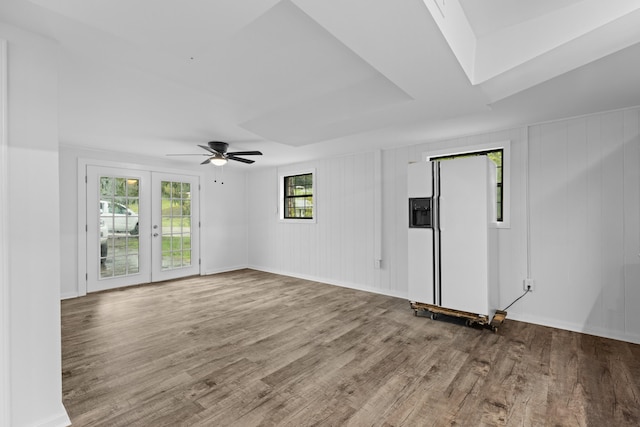 empty room featuring french doors, ceiling fan, and wood-type flooring