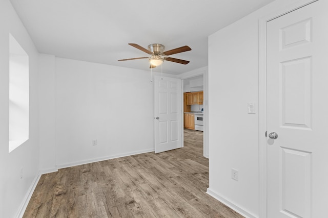 spare room featuring light wood-type flooring and ceiling fan