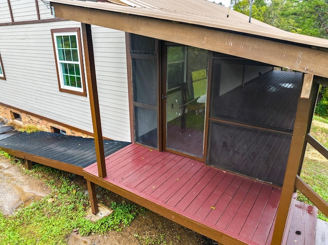 wooden deck featuring a sunroom