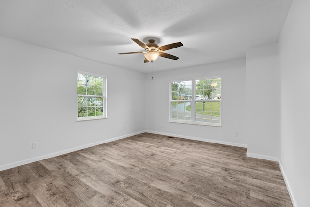 unfurnished room featuring ceiling fan and light hardwood / wood-style floors