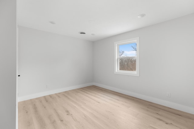 spare room featuring light wood-type flooring