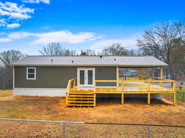 rear view of property with french doors and a wooden deck