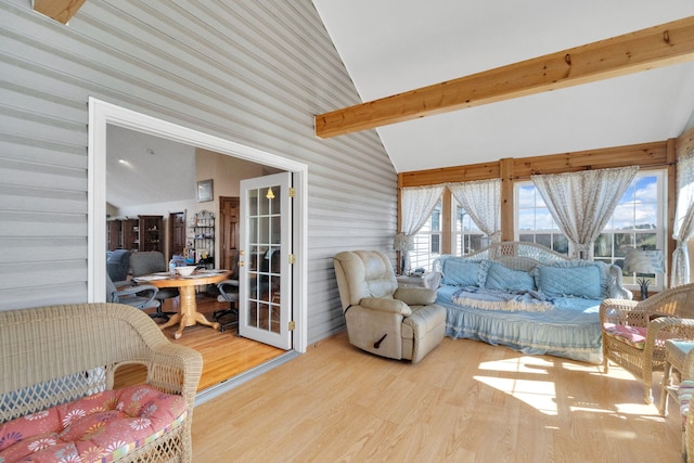 sunroom featuring vaulted ceiling with beams