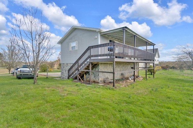 rear view of house with a lawn and a deck