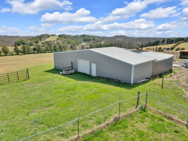 view of outdoor structure featuring a rural view and a yard