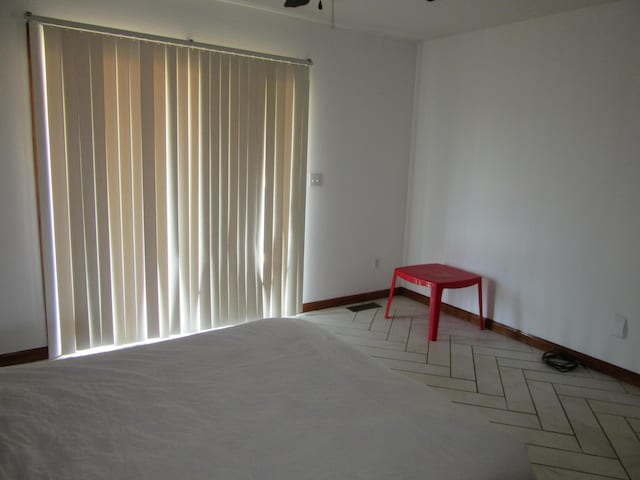 unfurnished bedroom featuring visible vents and baseboards