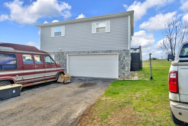 view of home's exterior featuring a lawn and a garage