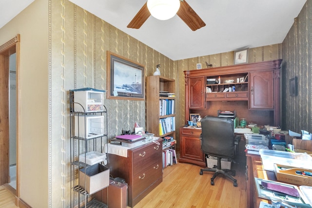 office space featuring wallpapered walls, light wood-style flooring, and ceiling fan