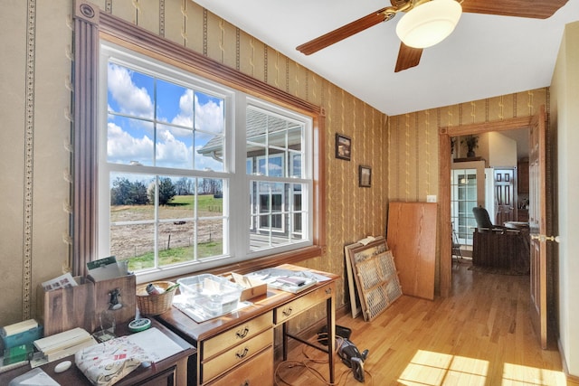 office space featuring light wood-type flooring, wallpapered walls, and ceiling fan