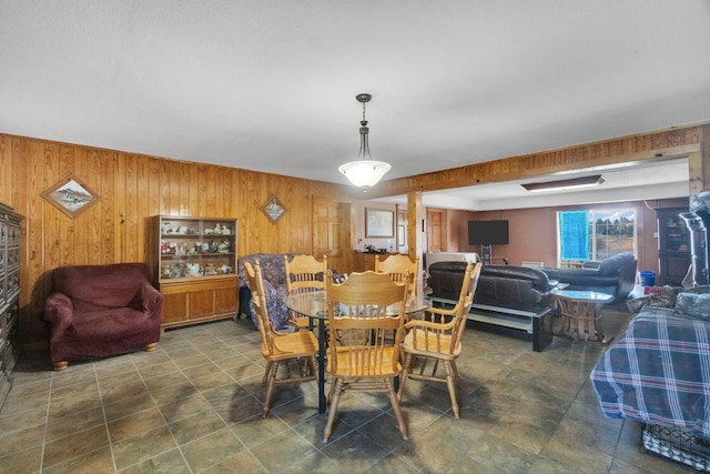 dining room featuring wooden walls