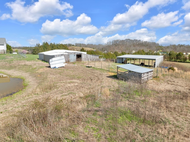 view of yard featuring an outbuilding and a rural view