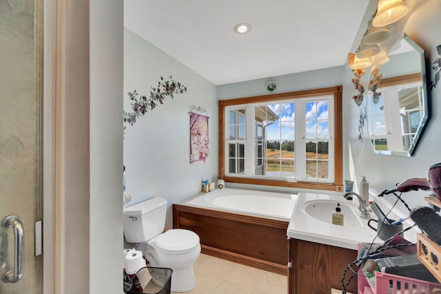 bathroom featuring recessed lighting, a garden tub, vanity, and toilet