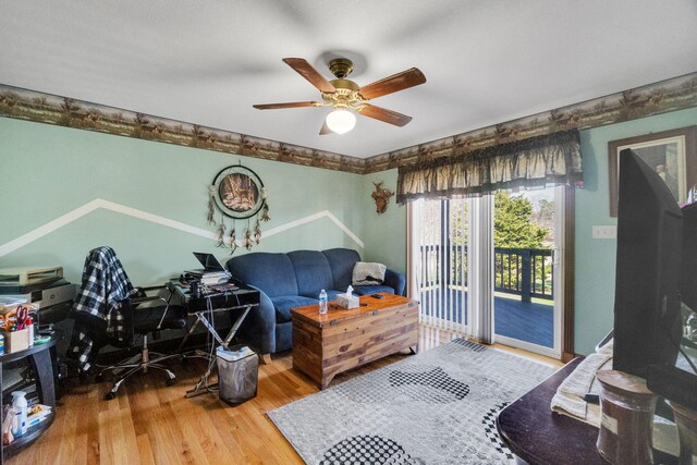 bedroom featuring access to outside, ceiling fan, and wood finished floors