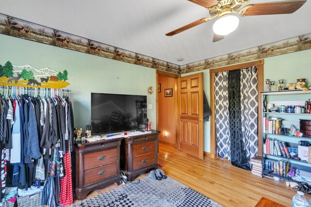 interior space with light wood-style floors and ceiling fan