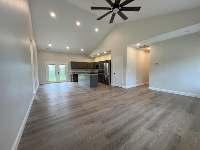 536 Sequoyah Dr, Morristown, TN 37813 - unfurnished living room with a ceiling fan, baseboards, wood finished floors, recessed lighting, and high vaulted ceiling