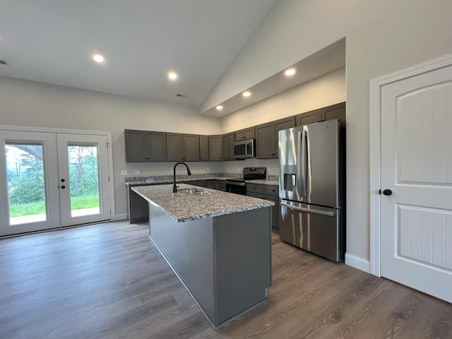 536 Sequoyah Dr, Morristown, TN 37813 - kitchen featuring appliances with stainless steel finishes, a kitchen island with sink, wood finished floors, light stone countertops, and recessed lighting
