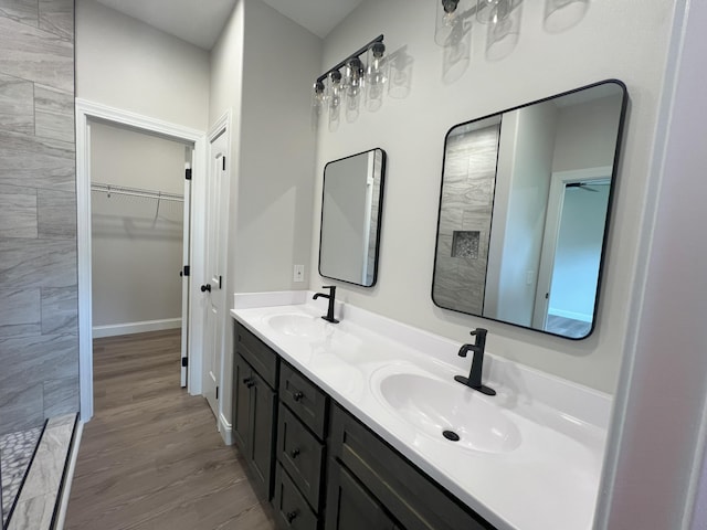 536 Sequoyah Dr, Morristown, TN 37813 - full bathroom with double vanity, tiled shower, a spacious closet, and wood finished floors