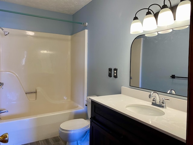 full bathroom featuring vanity, wood-type flooring, a textured ceiling, bathtub / shower combination, and toilet