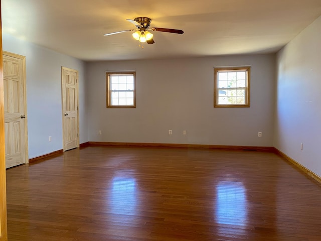 unfurnished room with ceiling fan and dark hardwood / wood-style floors