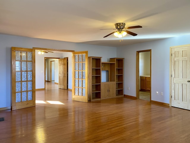 unfurnished living room with ceiling fan and hardwood / wood-style floors