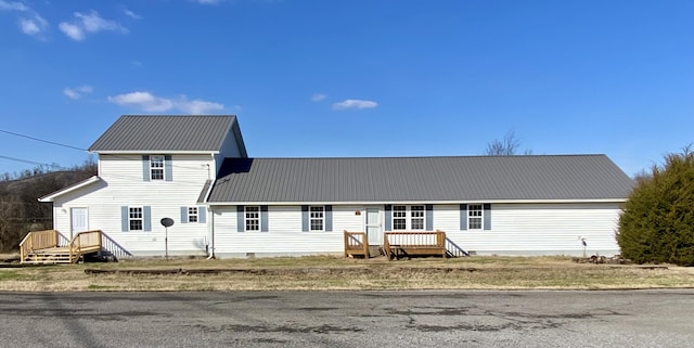 view of front of property with crawl space, metal roof, and a deck