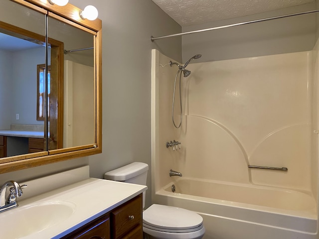 full bathroom with vanity, toilet, shower / washtub combination, and a textured ceiling