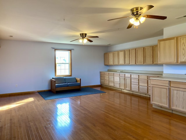 kitchen featuring light brown cabinets, ceiling fan, and light wood-type flooring