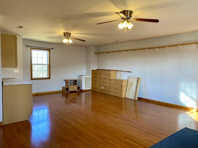 interior space with wood-type flooring and ceiling fan