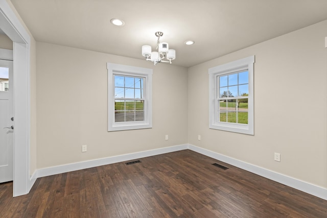 unfurnished room featuring a wealth of natural light, visible vents, and a notable chandelier