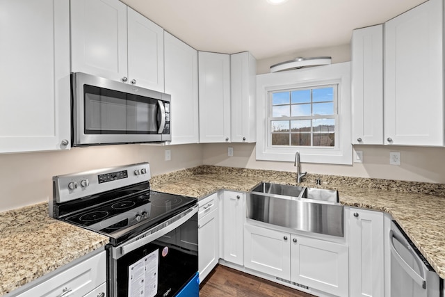kitchen featuring white cabinets, a sink, and appliances with stainless steel finishes