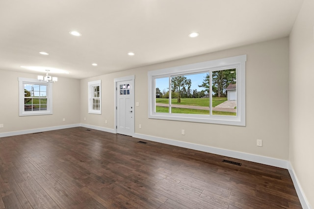 entrance foyer with baseboards, a notable chandelier, recessed lighting, and dark wood-type flooring