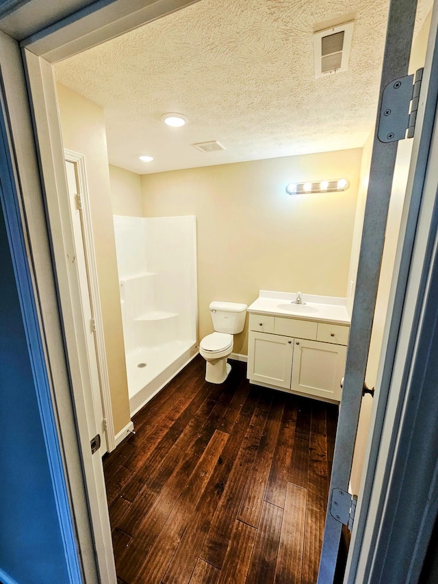 269 Buttercup Fields Rd, Newport, TN 37821 - full bathroom featuring wood-type flooring, toilet, a stall shower, a textured ceiling, and vanity