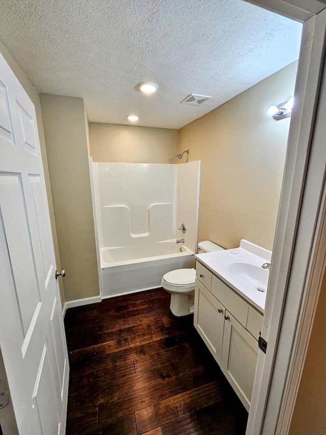 269 Buttercup Fields Rd, Newport, TN 37821 - bathroom with hardwood / wood-style floors, washtub / shower combination, toilet, a textured ceiling, and vanity
