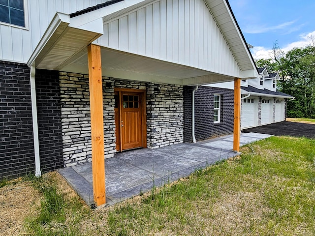 269 Buttercup Fields Rd, Newport, TN 37821 - property entrance with board and batten siding, brick siding, a porch, and driveway