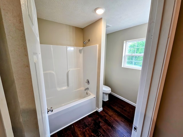269 Buttercup Fields Rd, Newport, TN 37821 - full bath featuring hardwood / wood-style floors, a textured ceiling, toilet, baseboards, and shower / washtub combination