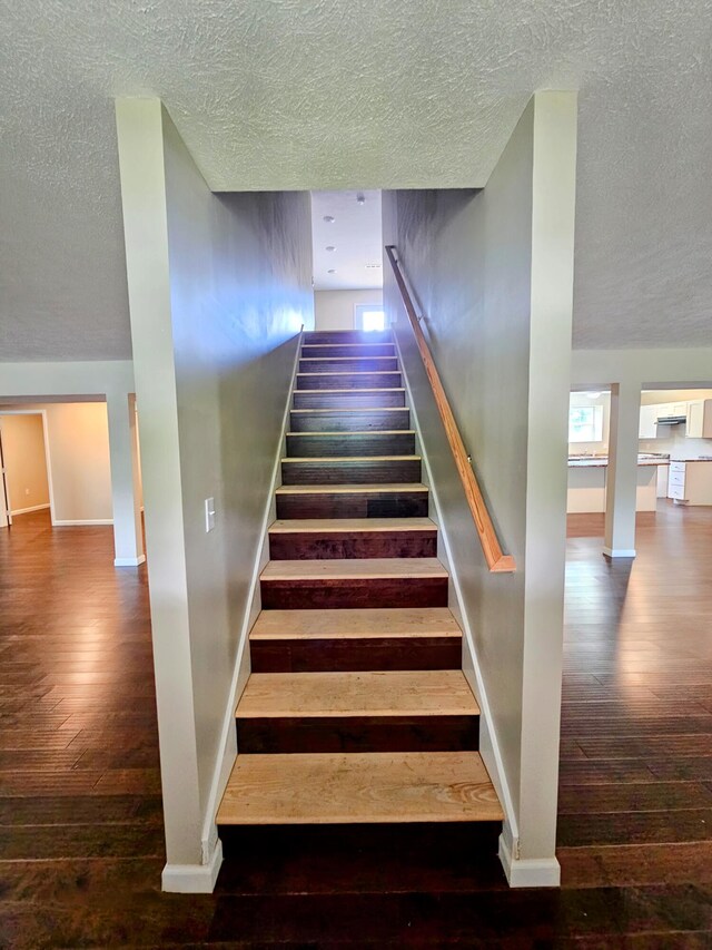 269 Buttercup Fields Rd, Newport, TN 37821 - staircase with a textured ceiling, wood-type flooring, and baseboards