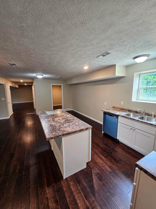 269 Buttercup Fields Rd, Newport, TN 37821 - kitchen with dishwashing machine, a sink, dark wood-style flooring, white cabinetry, and a textured ceiling