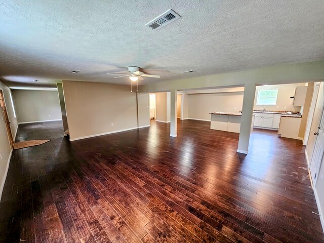 269 Buttercup Fields Rd, Newport, TN 37821 - basement featuring a textured ceiling, dark wood-style flooring, a ceiling fan, and baseboards