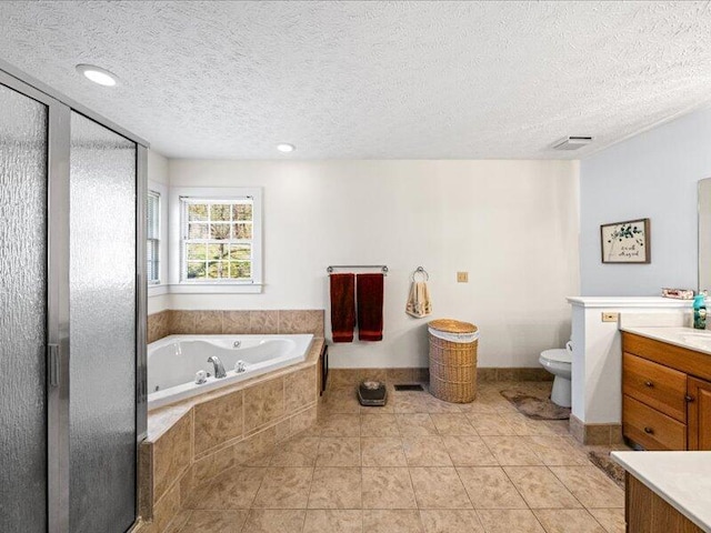 702 John Sevier Dr, Sevierville, TN 37876 - bathroom featuring a whirlpool tub, vanity, a textured ceiling, and toilet