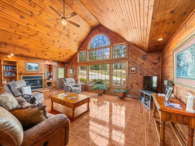 702 John Sevier Dr, Sevierville, TN 37876 - tiled living room featuring wood ceiling, wooden walls, ceiling fan, and plenty of natural light