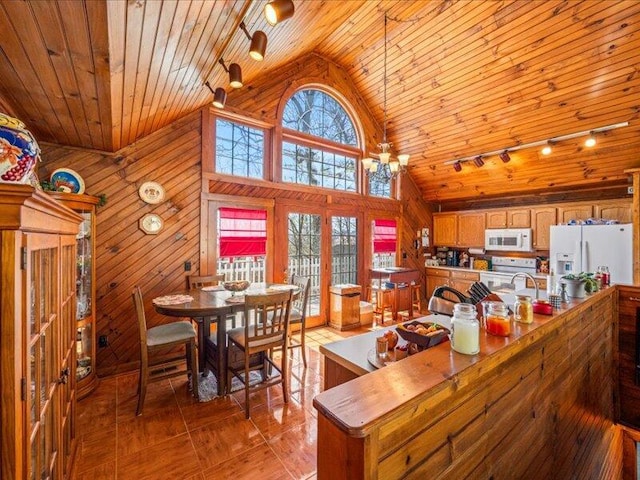 702 John Sevier Dr, Sevierville, TN 37876 - dining space with wood walls, high vaulted ceiling, rail lighting, and wood ceiling