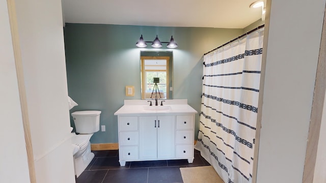 bathroom featuring tile patterned floors, toilet, vanity, and walk in shower