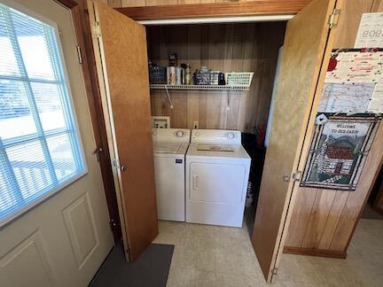 515 Mountain Lake Way, Newport, TN 37821 - clothes washing area featuring wooden walls, washing machine and clothes dryer, and laundry area