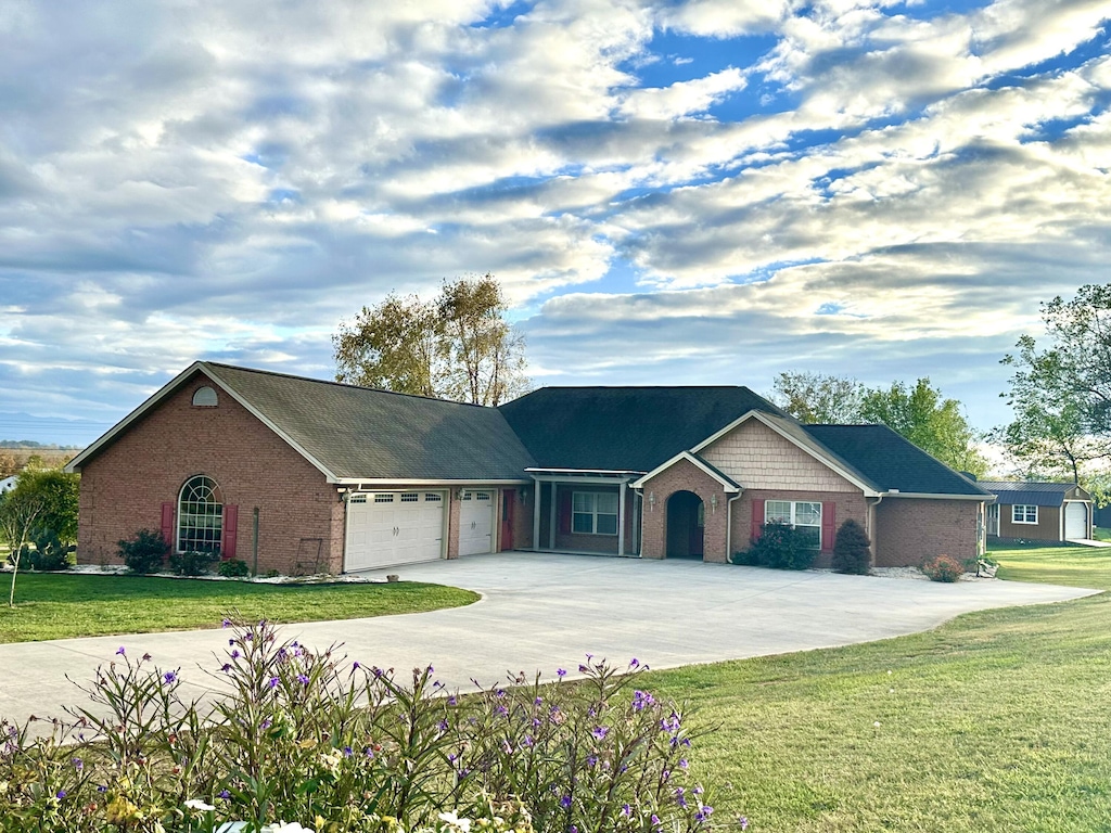 ranch-style house with a front yard and a garage